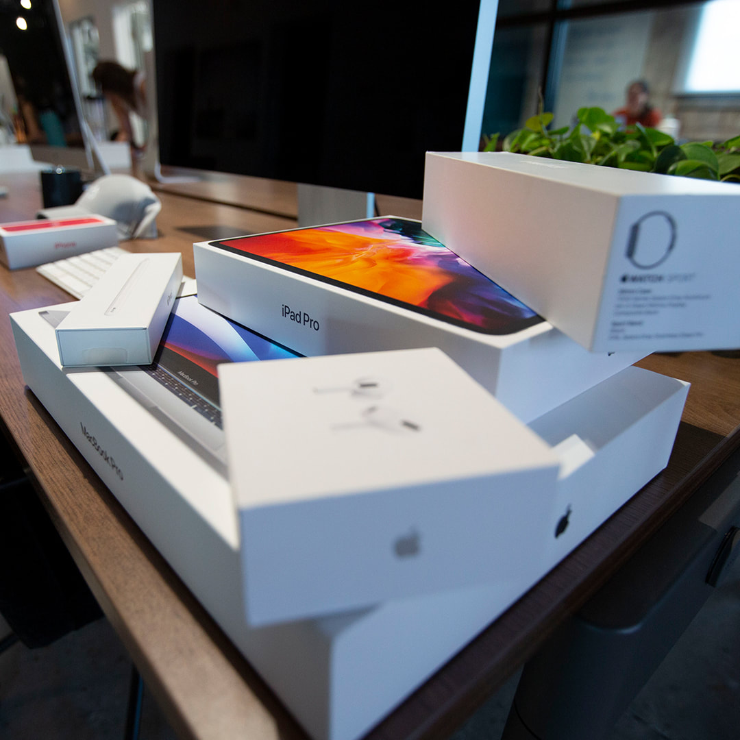 Boxes of various apple products on a desk